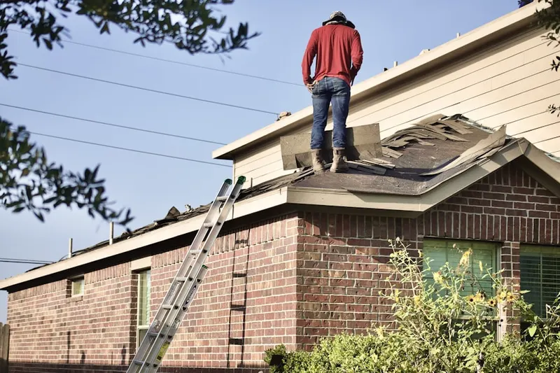 Professional roofer working on a residential roof in Lemoore Station